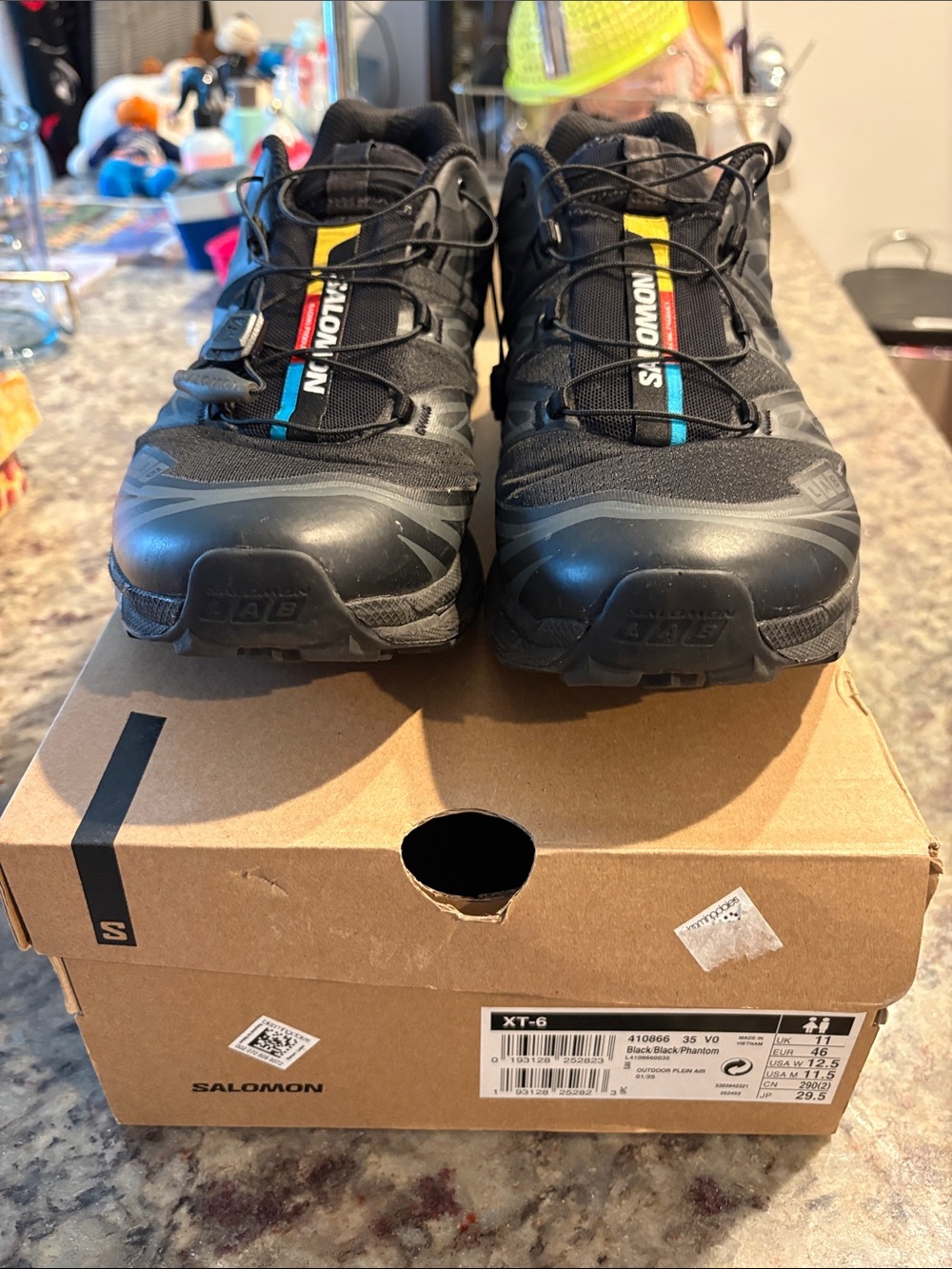 Salomon Black Trail Runners with Blue and Yellow Accents